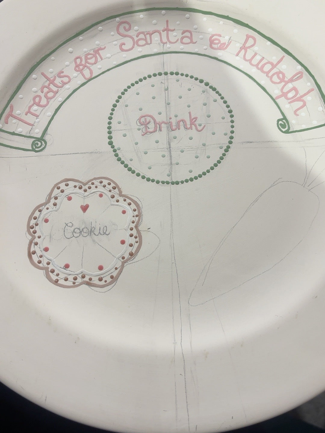 Hand-painted personalised Christmas plate showing biscuit-brown dots around a white iced cookie